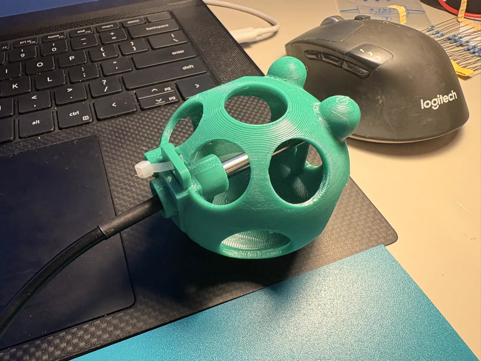 Green 3D printed frog enclosure with the metal temperature probe installed