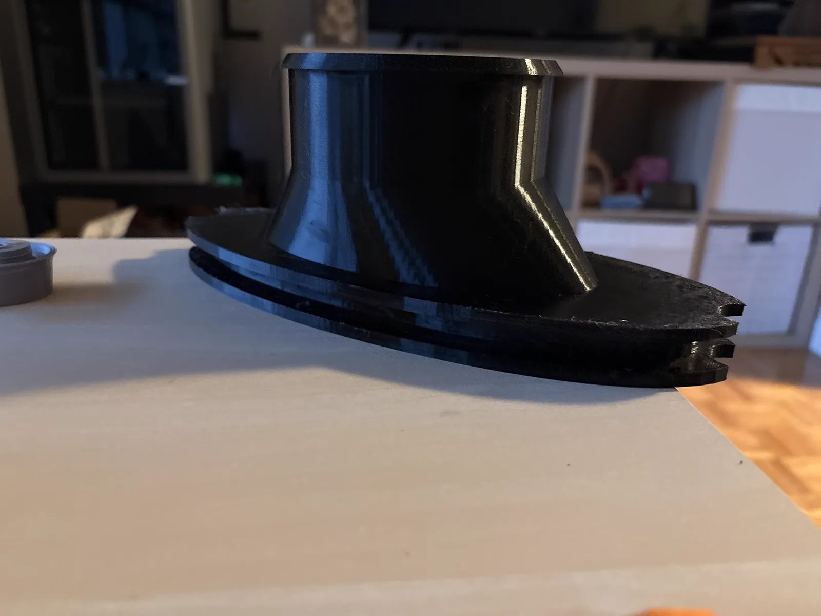 Black printed duct seen from the side, showing the groove that holds the tent zipper